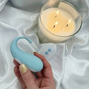 blue whale vibrator with remote control on satin background